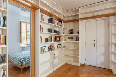 a room with white bookshelves and a door at Terrazza di Flamy - WelcomeToRhome in Rome