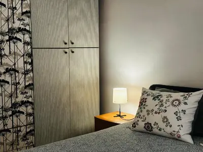 a bedroom with a bed with a pillow and a cabinet at Little Colosseum Gem in Rome