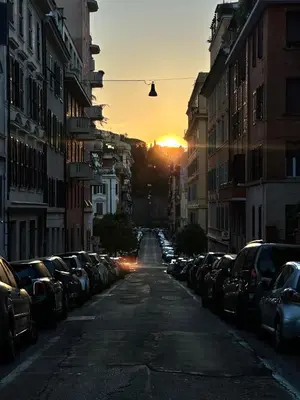 a city street with cars parked on the sides of the road at Little Colosseum Gem in Rome