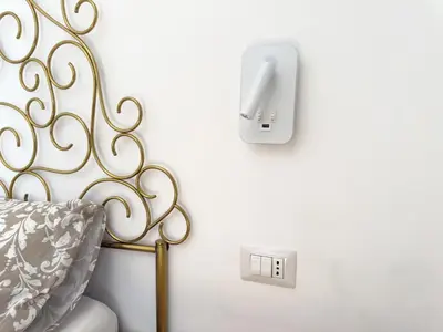 a bedroom with a bed and an electrical outlet at King Vatican Suite in Rome