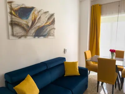 a living room with a blue couch and a table at King Vatican Suite in Rome