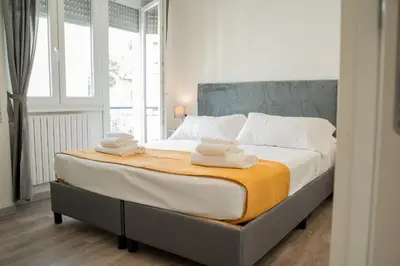 a bedroom with a large bed with towels on it at Salotto Tuscolano in Rome