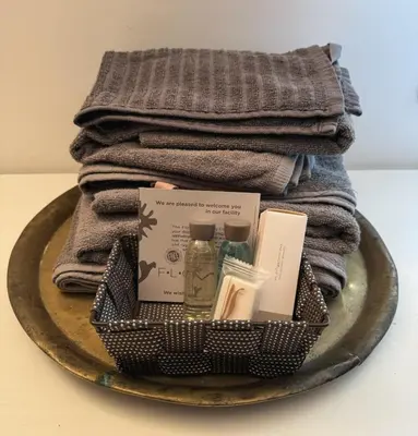 a basket of towels and a pile of towels at Appartamento Corso Trieste in Rome