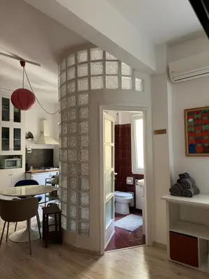 a room with a kitchen and a dining room at Appartamento Corso Trieste in Rome