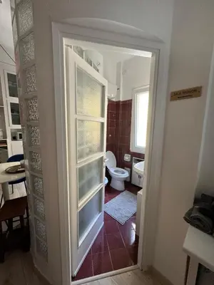 a bathroom with a toilet and a window at Appartamento Corso Trieste in Rome