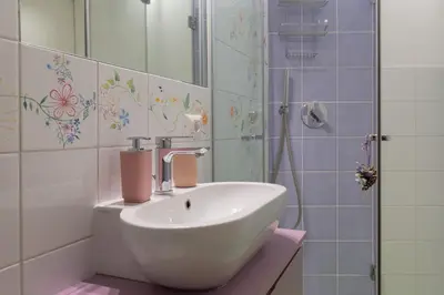 a bathroom with a sink and a shower at La Buganvillea locazione turistica in Rome