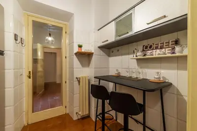 a small kitchen with a table and two chairs at Trevi Garden Suite in Rome