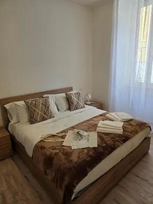 a bedroom with a large bed with a tray on it at Di Lollo Comfort Suites in Rome