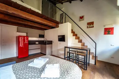 a room with a bed and a red refrigerator at Le Lune Apartment in Rome