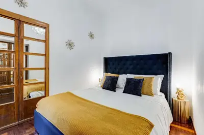 a bedroom with a large bed and a mirror at New Spanish Square - RomeDreamHome in Rome