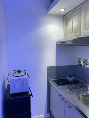 a kitchen with a stove and a blue light at Orchidea Bianca Home in Rome