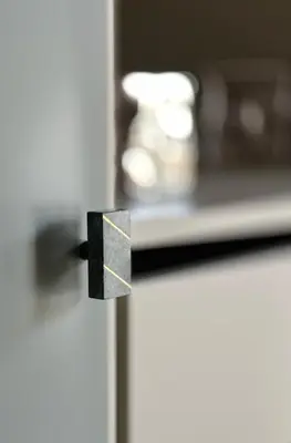 a black door knob on a white refrigerator at CEMMA luxury apartment in Rome