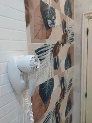 a bathroom with a blow dryer on a wall at Alloggio vicino Termini La Casetta in Rome