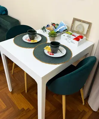 a white table with two plates and two cups at Alloggio vicino Termini La Casetta in Rome