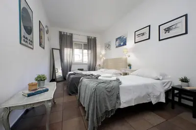 a hotel room with two beds and a table at 4BNB - Otello in Rome