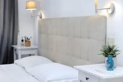a bedroom with a white bed and a table at 4BNB - Otello in Rome