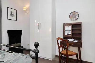 a bedroom with a bed and a desk and a chair at 4BNB - Otello in Rome