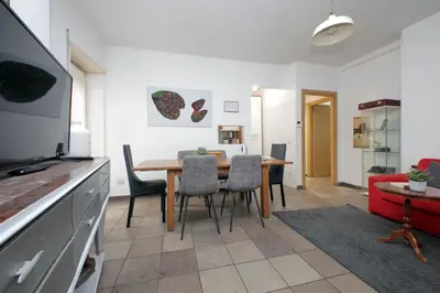 a kitchen and dining room with a table and chairs at 4BNB - Otello in Rome