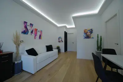 a living room with a white couch and a table at Suites Conca D'Oro, Roma in Rome