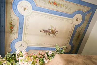 a ceiling with a painting of a bug on it at Nerva Accommodation Cavour in Rome