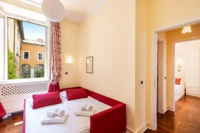 a bedroom with a bed and a large window at Baccina Apartment by Rental in Rome in Rome