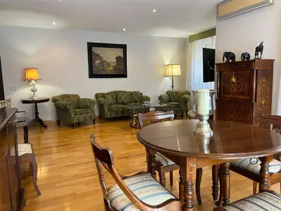a living room with a table and chairs at Tiziano House by Ghor in Rome