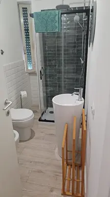 a bathroom with a sink and a toilet and a shower at CAFE Balduina in Rome
