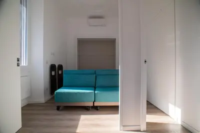 a blue couch in a room with a mirror at Luxury Apartment - Vatican Area - Key Collection in Rome