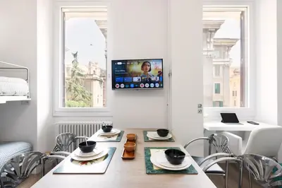 a dining room with a table with chairs and a tv at Luxury Apartment - Vatican Area - Key Collection in Rome