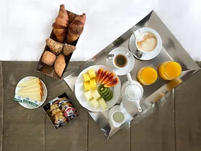 a table with a tray of breakfast foods and coffee at Casa Montani in Rome