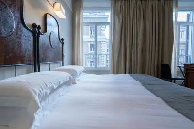 a bedroom with two beds and a large window at Casa Montani in Rome