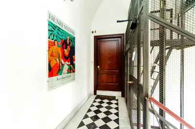 a hallway with a door and a checkered floor at Roma Colosseo, vista da sogno in Rome