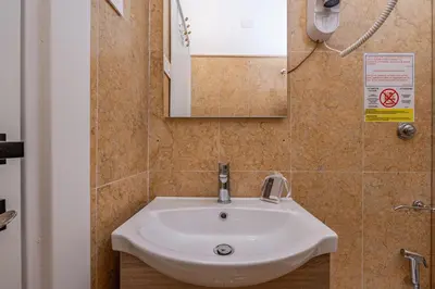 a white sink in a bathroom with a mirror at Residenza Degli Speziali Roma Prati in Rome