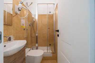 a bathroom with a toilet and a sink and a shower at Residenza Degli Speziali Roma Prati in Rome
