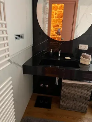 a bathroom with a black sink and a mirror at Luxury Loft near Via Veneto in Rome