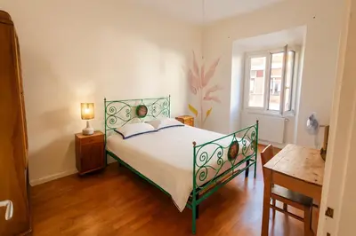 a bedroom with a bed and a table and a window at Aurelio APT - Homkeey Apartments in Rome