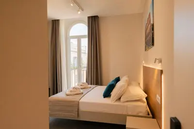 a bedroom with a bed with a window at imperium suite trevi in Rome