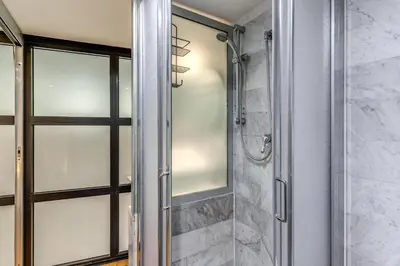 a shower with a glass door in a bathroom at Rosa Trastevere Magic Location in Rome