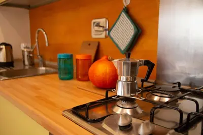 a kitchen counter with a stove and a pumpkin at La casetta nascosta in Rome