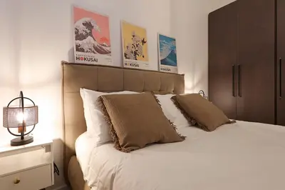 a bedroom with a large white bed with two pillows at Bologna Garden House in Rome