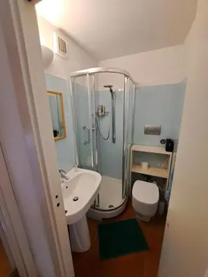 a bathroom with a shower and a toilet and a sink at Terrazza Trastevere Apartment in Rome
