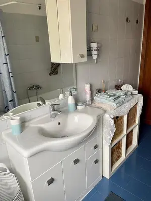 a bathroom with a white sink and a mirror at La Casa di Valentina in Rome