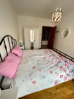 a bedroom with a large bed with pink pillows at La Casa di Valentina in Rome