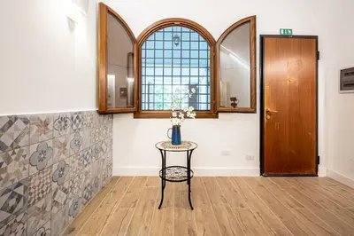 a room with a table with flowers on it at Domus Piramide in Rome