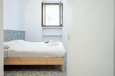 a bedroom with a bed and a window at Domus Piramide in Rome