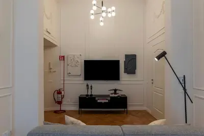 a living room with a tv and a couch at Castro Pretorio 21 - FromHometoRome in Rome