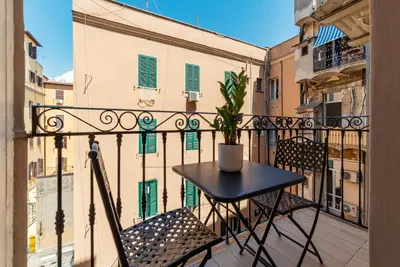 a small table and chairs on a balcony at Castro Pretorio 21 - FromHometoRome in Rome
