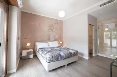 a bedroom with a bed and a wall at VaticanRhome II in Rome