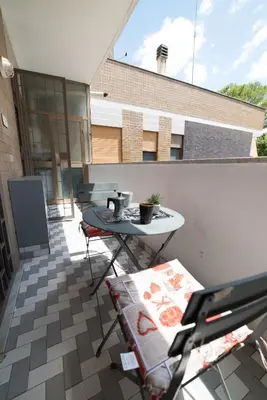 a balcony with a table and chairs on a building at VaticanRhome II in Rome