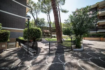a building with a gate and trees in a courtyard at VaticanRhome II in Rome